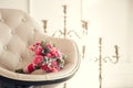 Wedding bouquet on a soft armchair against the background of candelabra Royalty Free Stock Photo