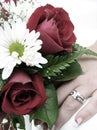 Bride's wedding ring hand and bouquet closeup
