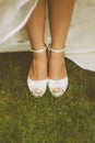 Bride's White Shoes on a Grass Floor
