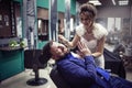 Bride shaves groom with a straight razor Royalty Free Stock Photo