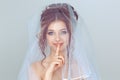 Bride shh woman wide eyed asking for silence secrecy with finger on lips hush hand gesture white
