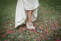 Bride shoes stepping on confetti on the floor Royalty Free Stock Photo