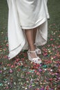 Bride shoes stepping on confetti on the floor Royalty Free Stock Photo