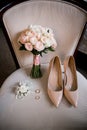 Bride shoes with wedding gold rings and bouquet Royalty Free Stock Photo