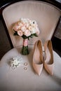 Bride shoes with wedding gold rings and bouquet Royalty Free Stock Photo