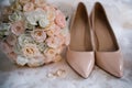 Bride shoes with wedding gold rings and bouquet Royalty Free Stock Photo
