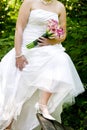 Bride showing off wedding dress and shoes