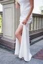 Bride shows her tanned slim leg with garter Royalty Free Stock Photo