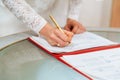 Bride signing signature on wedding certificate Royalty Free Stock Photo