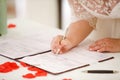 Bride signs marriage certificate Royalty Free Stock Photo