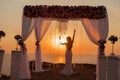 Bride silhouette. Wedding ceremony arch with flower arrangement