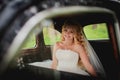 Bride sitting in car and smile Royalty Free Stock Photo