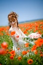 Bride sitting in field of flowers