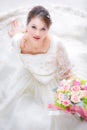 Bride sitting and holding a bouquet of flowers Royalty Free Stock Photo