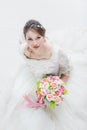 Bride sitting and holding a bouquet of flowers Royalty Free Stock Photo