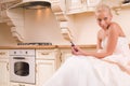 Bride sitting in the kitchen before the wedding