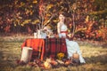 Bride sitting near the table in autumn forest Royalty Free Stock Photo