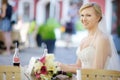 Bride sitting at an outdoor cafe