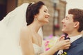 Bride smiles adjusting groom's blue bow tie Royalty Free Stock Photo