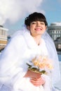 Bride smiles and holds bouquet of roses