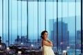 Bride smiles posing in an empty panoramic cafe Royalty Free Stock Photo
