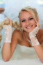 Bride smiling holding hair.