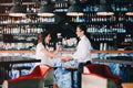 Bride smiling and laughs while groom dancing with her in the bar. Expressive and emotional wedding couple. Royalty Free Stock Photo