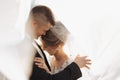 Wedding portrait. The groom in a black suit and the blonde bride are hugging Royalty Free Stock Photo