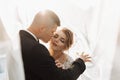 Wedding portrait. The groom in a black suit and the blonde bride are hugging Royalty Free Stock Photo