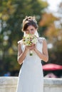 Bride sniffs bridal nosegay on open air Royalty Free Stock Photo