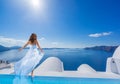 Bride standing on the edge on the infinity pool
