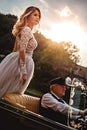 Bride standing proud in a classic convertible Royalty Free Stock Photo