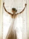 The bride standing on the window Royalty Free Stock Photo