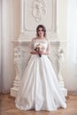 The bride stands near a large fireplace Royalty Free Stock Photo