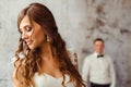 Bride stands thoughtful