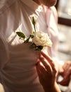 Bride straightens the groom`s boutonniere