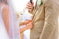 The bride straightens the groom& x27;s jacket during the wedding ceremony.