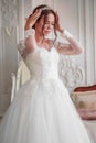 The bride straightens her wedding tiara on her head