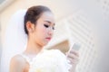 Bride talking on cell phone in wedding dress Royalty Free Stock Photo