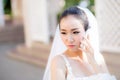 Bride talking on cell phone in wedding dress Royalty Free Stock Photo