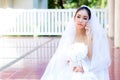Bride talking on cell phone in wedding dress Royalty Free Stock Photo