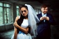 Bride with tearful face and groom with sly smile