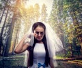 Bride with tearful face, pine forest on background