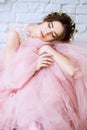 Bride in a tender light pink wedding dress in a morning