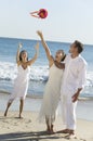 Bride throwing bouquet woman trys to catch it