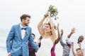 Bride throwing flower bouquet to guests