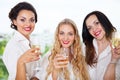 Bride to be and bridemaids holding glass with champagne