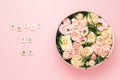 Bride to be lettering on the wooden squares with letters on the pink background and big round box with red flowers and
