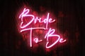 Bride to Be neon sign on a Dark Wooden Wall 3D illustration with Red heart background