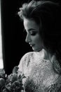 Bride in underwear and a white robe in the interior of hotel at a wedding